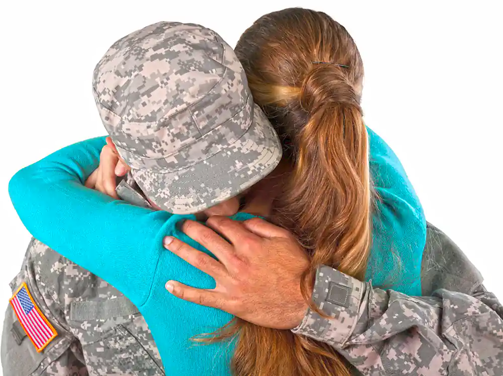 A girl hug militory guy around the neck