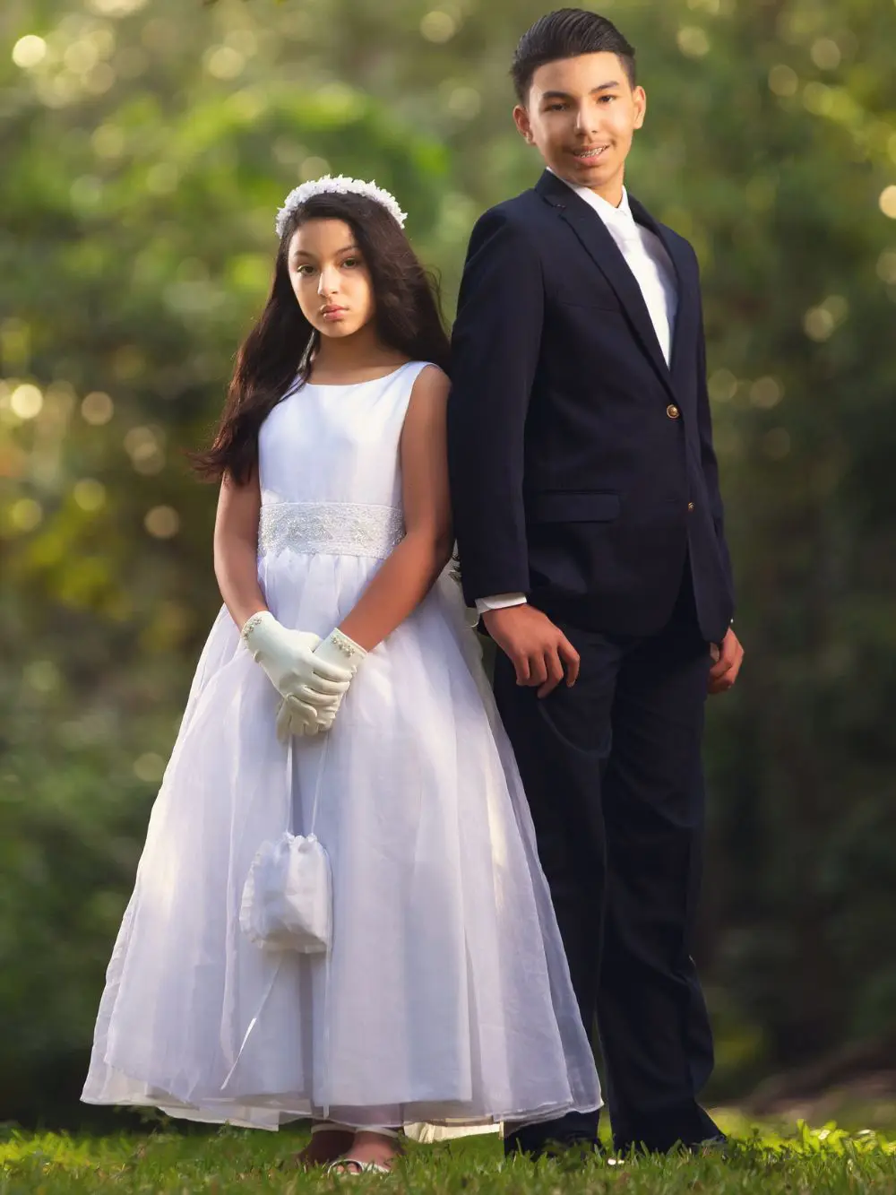 Siblings in white dress for first Holly communion