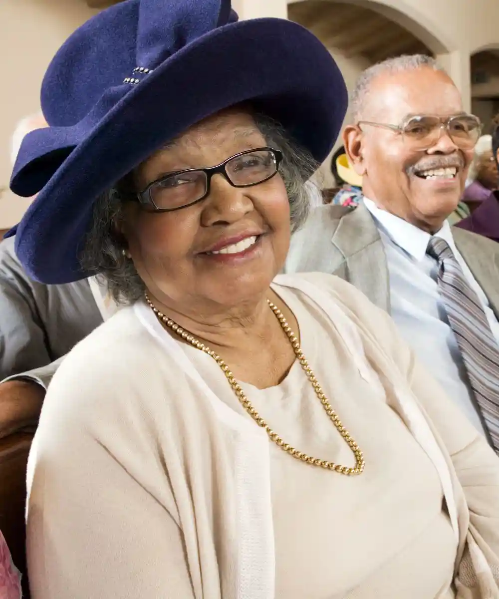 Senior woman in sunday best among congregation at church portrait