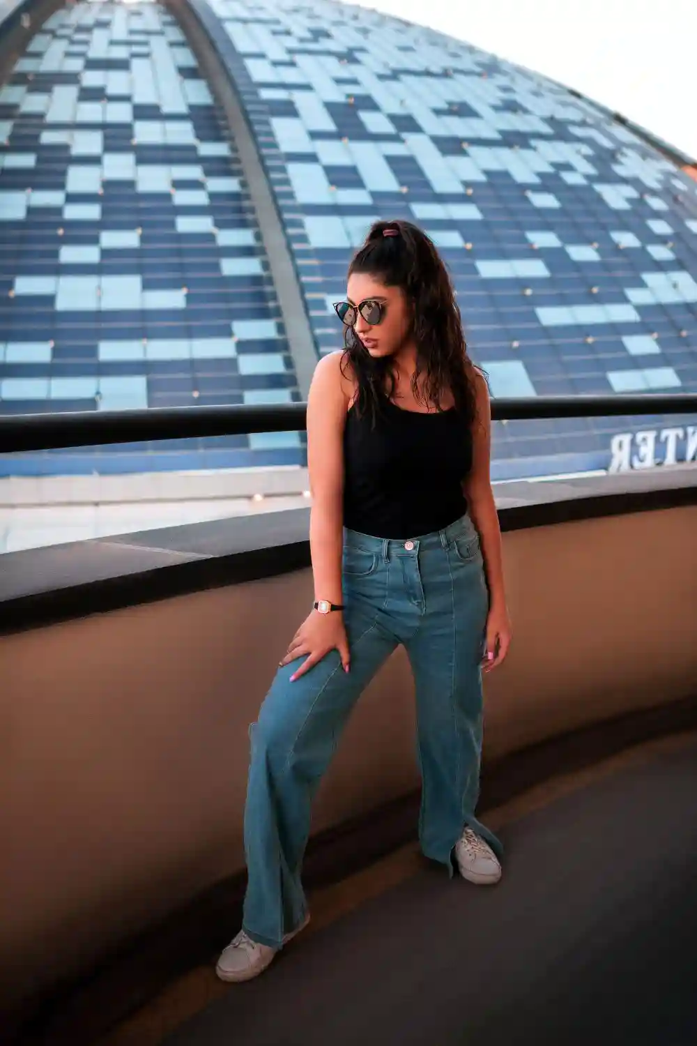 Woman in Black Top and Blue Denim Jeans