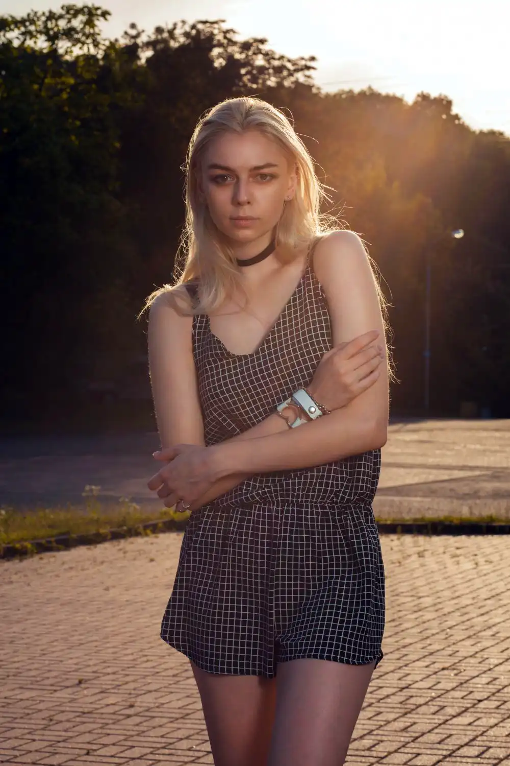 Blonde woman with long hair wearing black romper