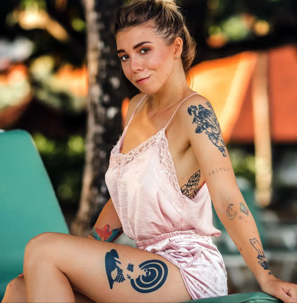 Woman posing on the tropical beach wearing romper