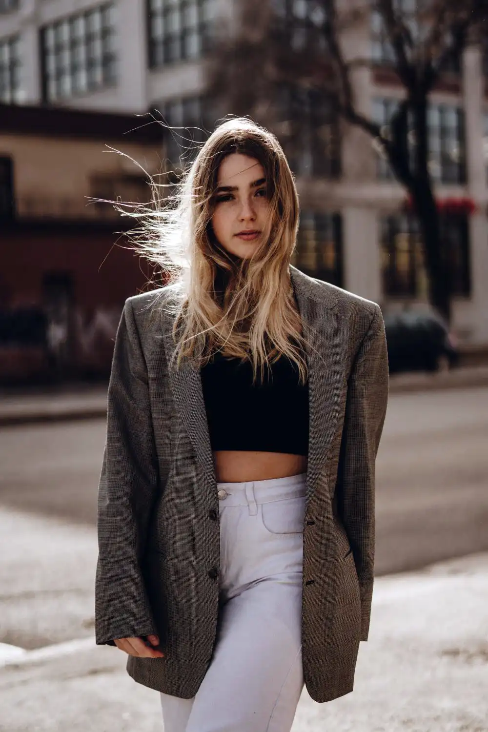 A Woman Wearing a Crop Top under a Blazer