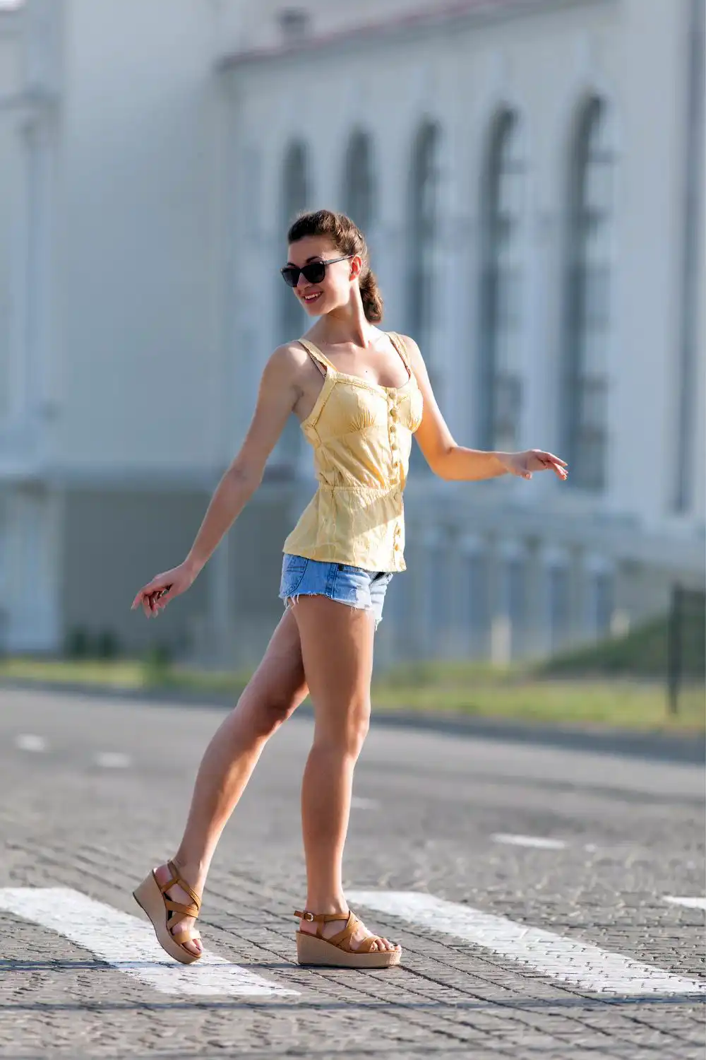 Woman in yellow sleeveless blouse